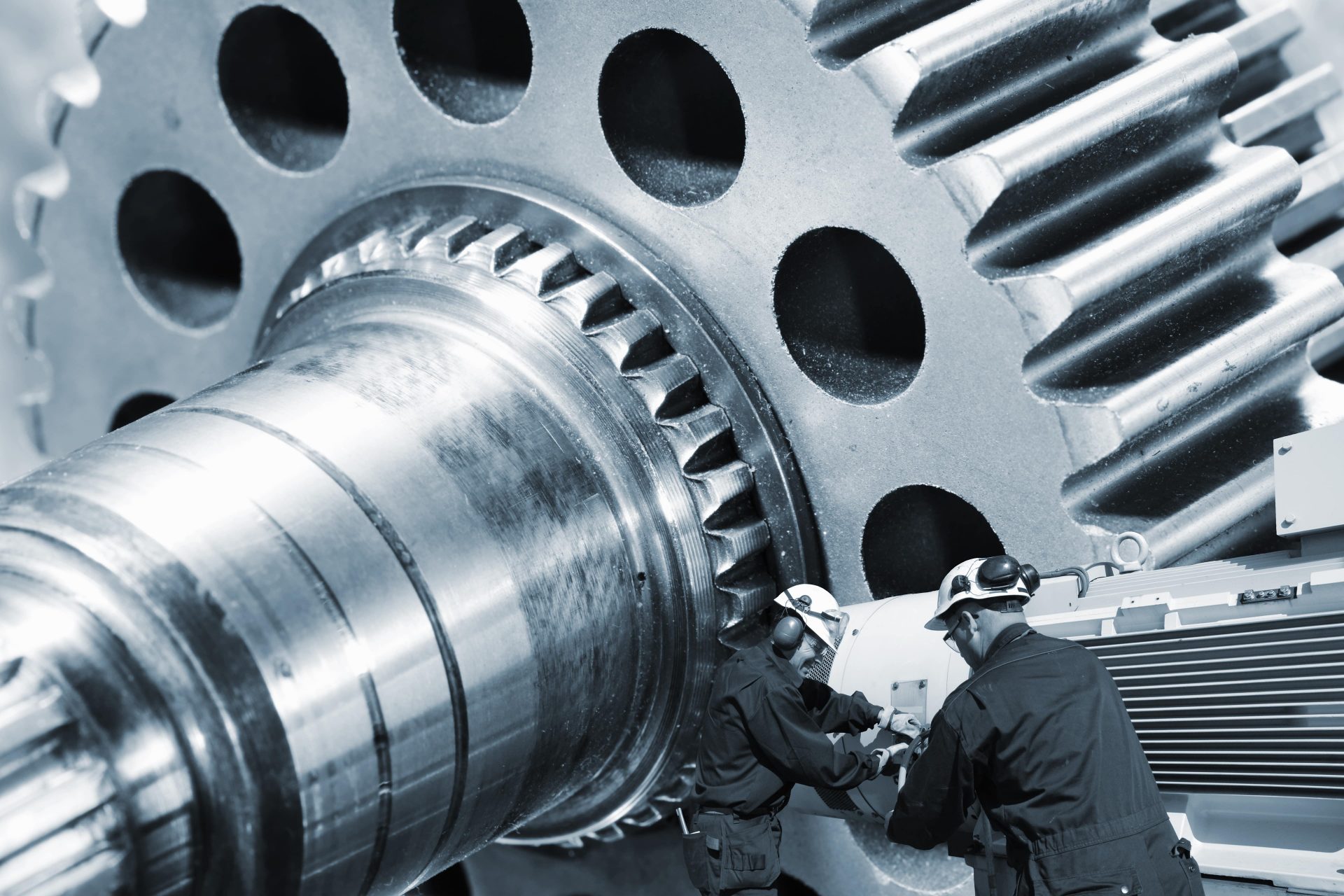Aerospace testing with workers inspecting the gear components