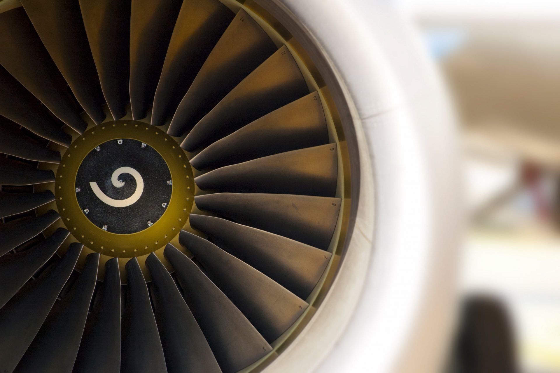 Close up of a jet engine with numbers on turbines and spiral center